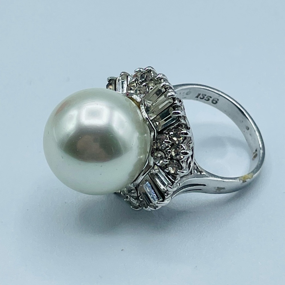 Pearl.  Round diamond ring